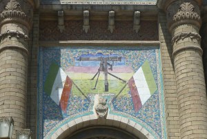 Detail from Bagh-e Melli Gate in central Tehran. Love the combination of traditional mosaics with the machine gun.